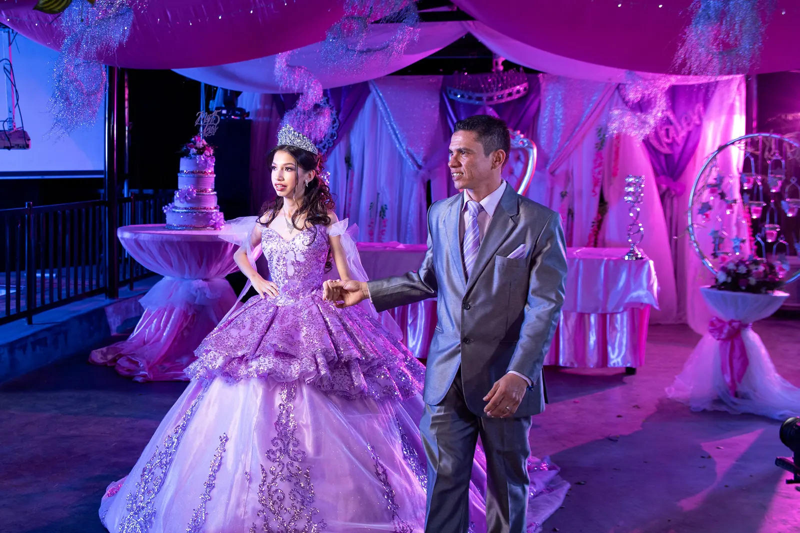 Quinceañera de lila entrando del brazo de su padre